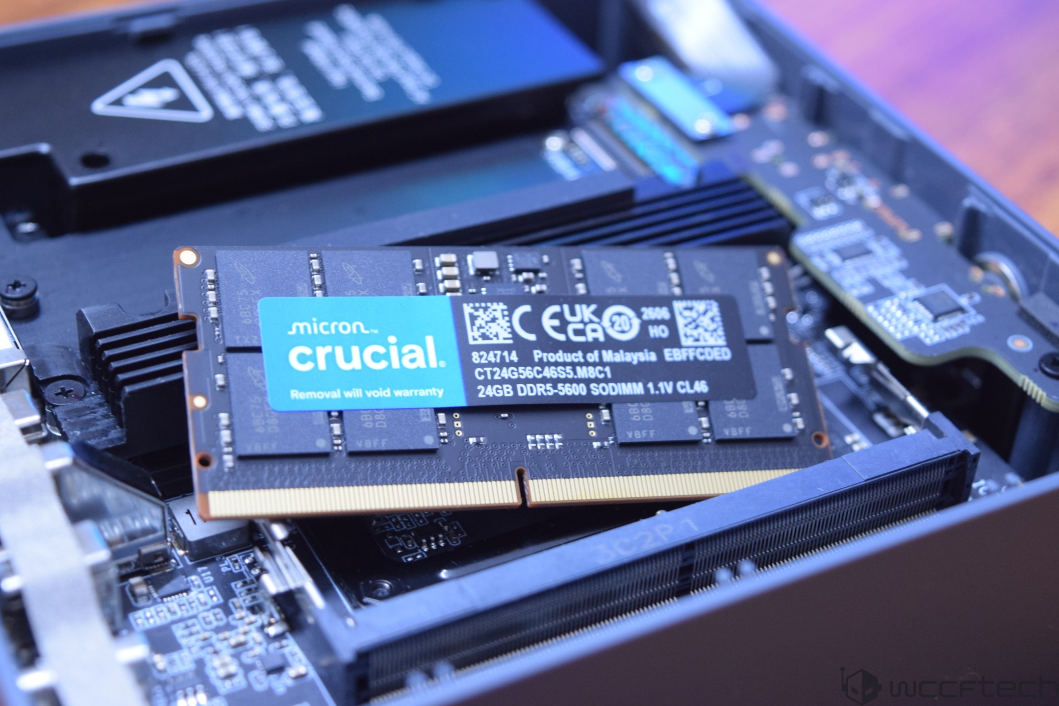 A Micron Crucial DDR5-5600 SO-DIMM module with 24GB DDR5-5600 SODIMM text is shown installed on a motherboard.