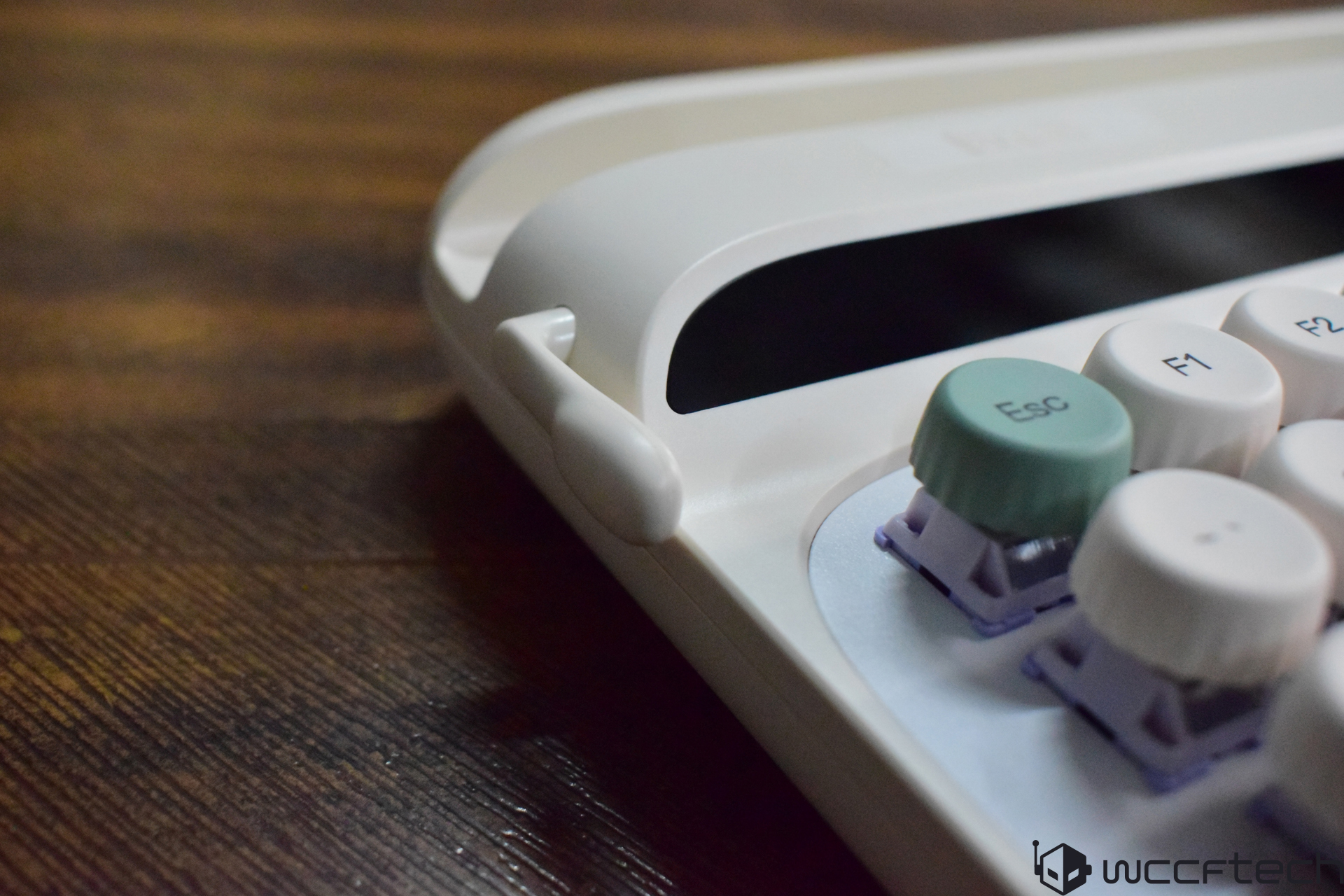 A close-up of a white mechanical keyboard with colorful round keycaps labeled 'Esc' and 'F1'.