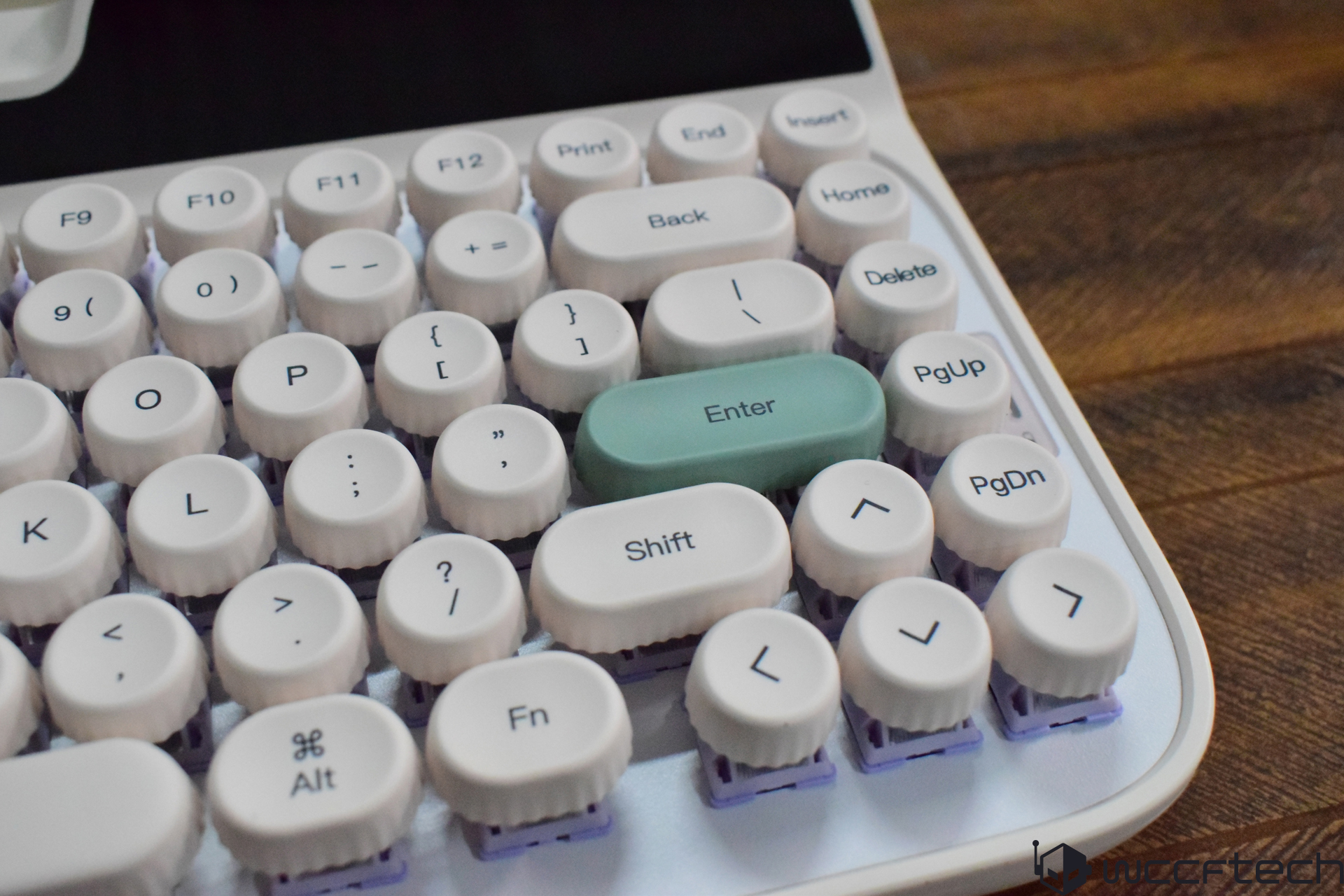 A retro-style keyboard with round white keys featuring a green 'Enter' key.