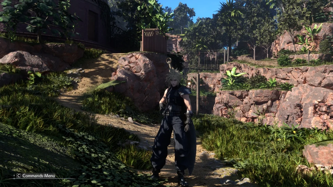 A character from 'Final Fantasy VII' stands on a grassy path surrounded by rocky terrain and lush vegetation, with the on-screen prompt 'Commands Menu' at the bottom left.
