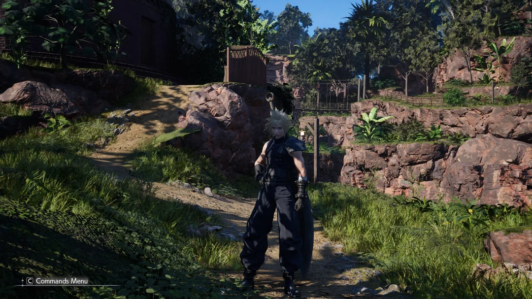 Cloud Strife stands on a rocky path surrounded by lush greenery in the game 'Final Fantasy VII Rebirth,' with a 'Commands Menu' icon visible in the bottom left corner.