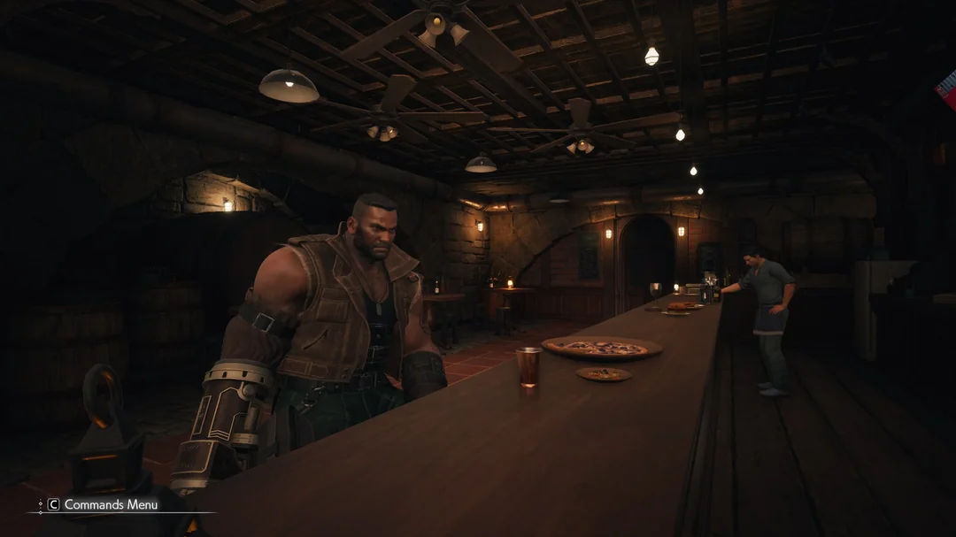 A character from 'Final Fantasy VII Remake' stands inside a rustic bar next to a long counter with drinks and pizzas.