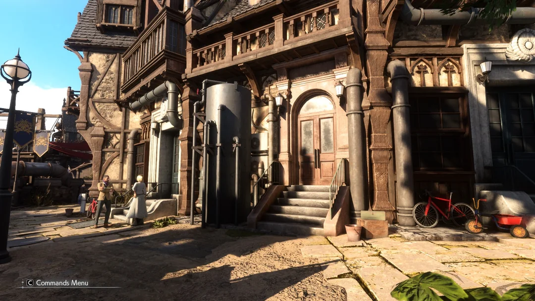 A detailed street scene from the game Fable shows a rustic building with wooden and stone architecture, a red bicycle, and industrial piping, with the on-screen text 'C Commands Menu' in the bottom left corner.