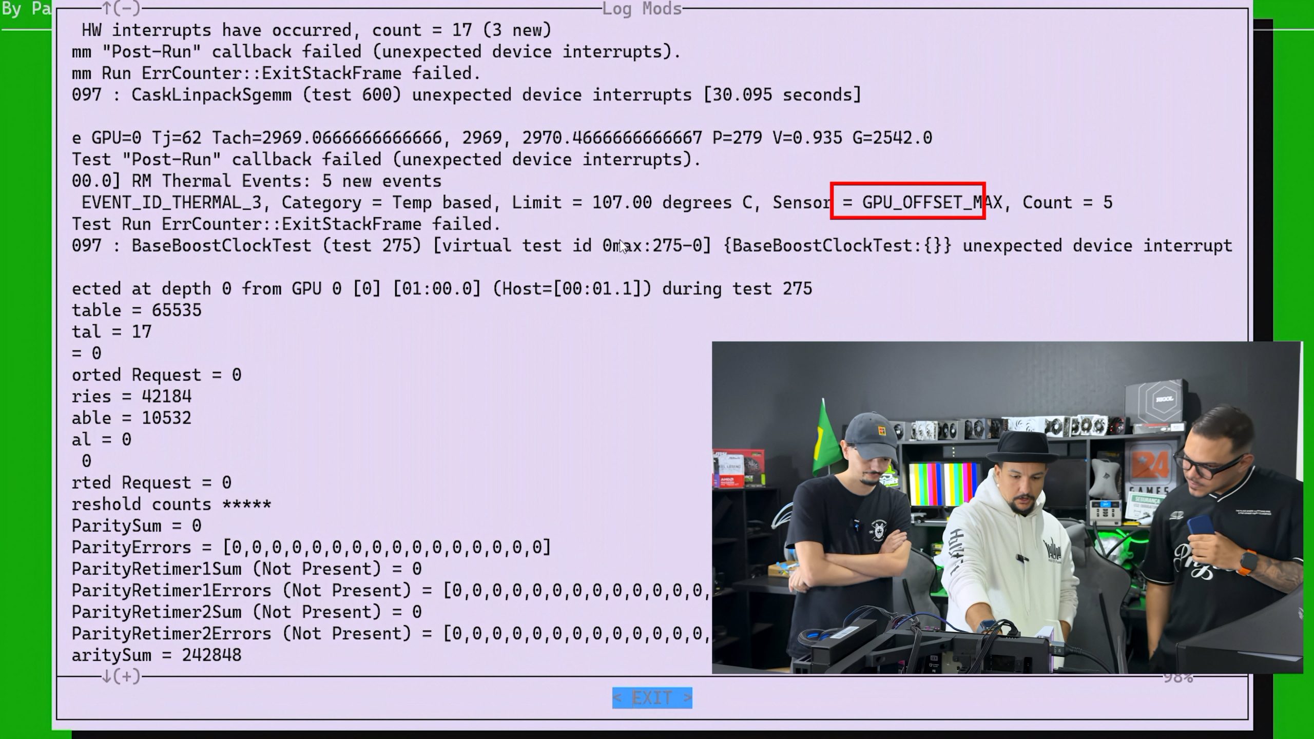 A computer screen displays diagnostic text with a highlighted section 'GPU_OFFSET_MAX,' accompanied by three individuals examining hardware in a tech room setup.