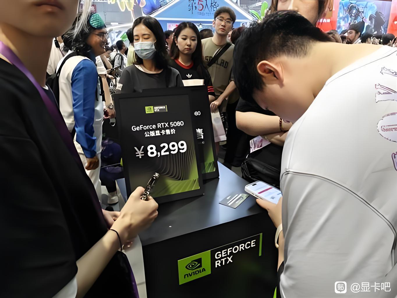 A crowd views an NVIDIA GeForce RTX 5080 display showing a price of ¥8,299 at an event.