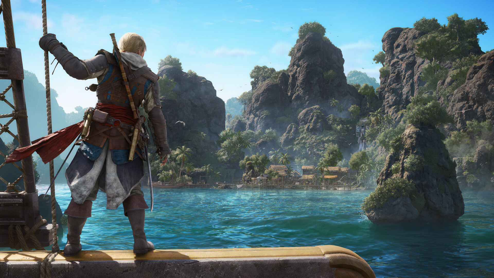 A character from Assassin's Creed IV: Black Flag stands on a ship, overlooking a tropical island with rocky cliffs and lush vegetation.
