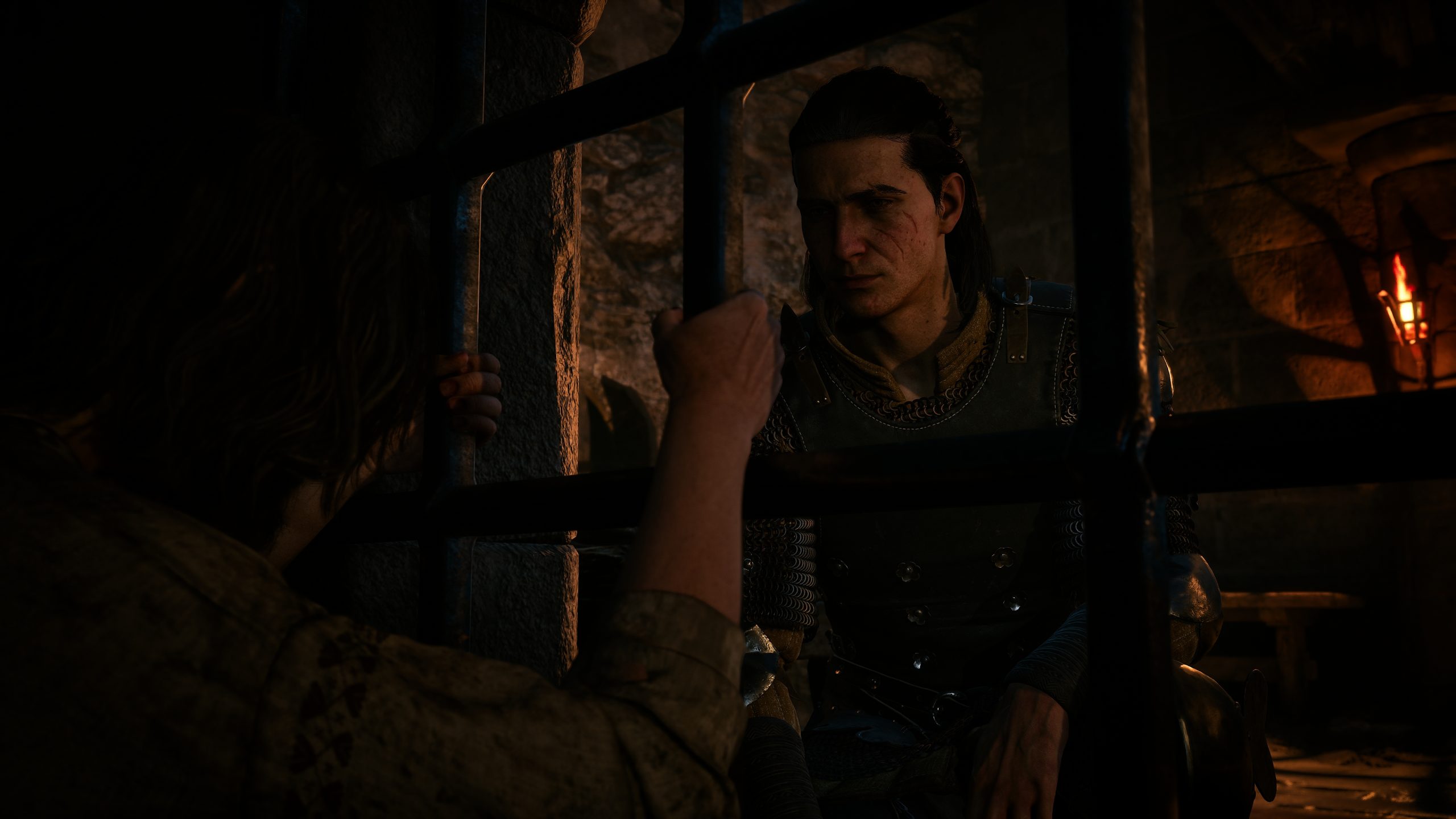 A character in the video game Baldur's Gate 3 is depicted speaking to someone through prison bars in a dimly lit dungeon setting.