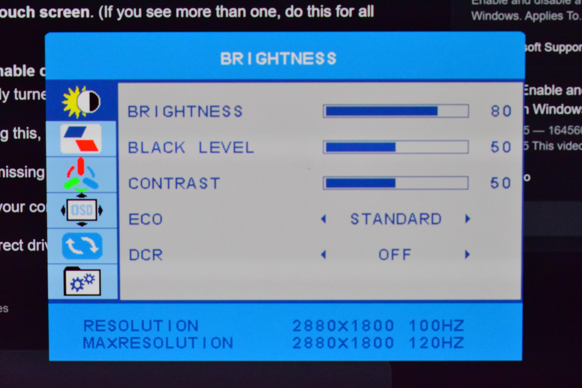 A monitor settings menu displays options for 'BRIGHTNESS,' 'BLACK LEVEL,' 'CONTRAST,' 'ECO,' 'DCR,' and shows resolution settings of 2880x1800 at 100Hz and 120Hz.