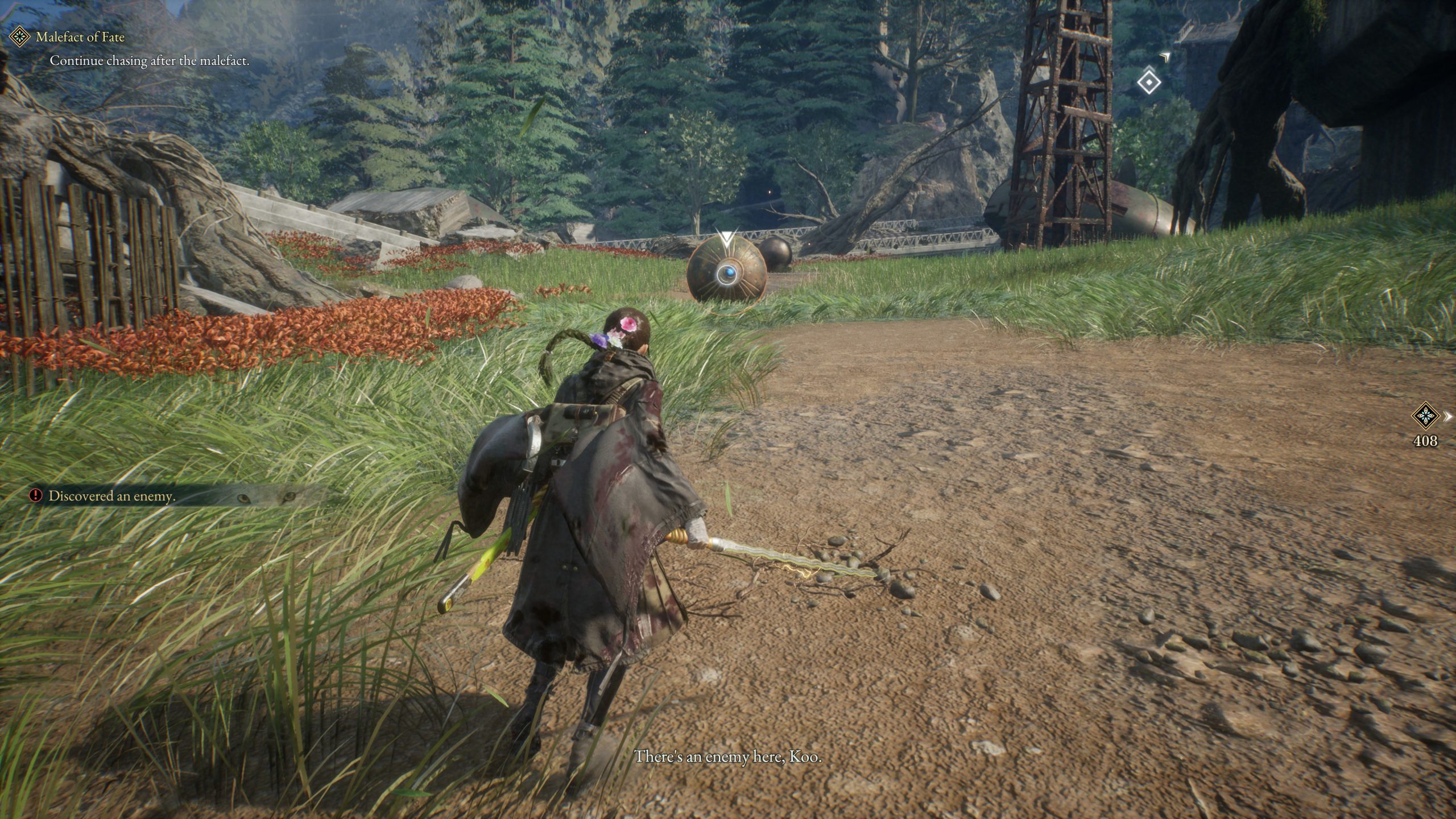 A character in a game alerting 'There's an enemy here, Koo' approaches a robotic enemy in a grassy, open landscape with the task 'Continue chasing after the malefact.'