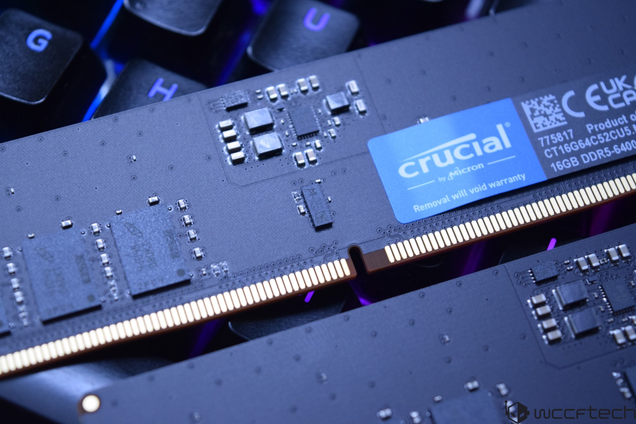 A close-up of Crucial by Micron 16GB DDR5-6400 memory module on a keyboard background.