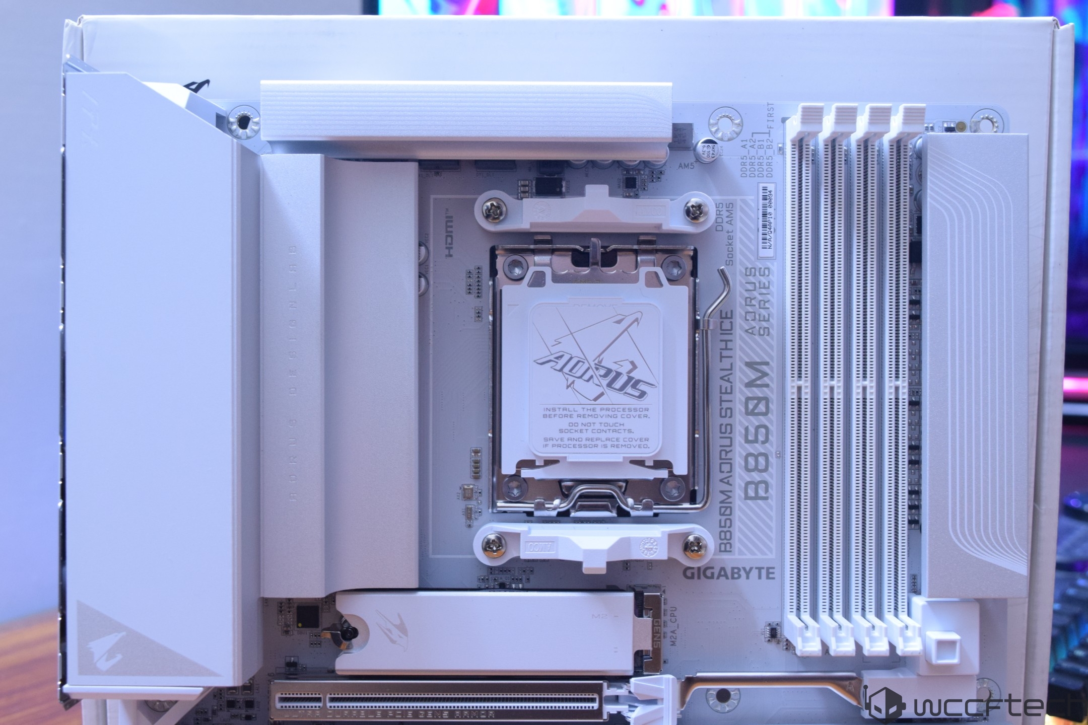 Gigabyte B650M AORUS STEALTH motherboard showcasing the CPU socket, DIMM slots, and branding on a white PCB background.