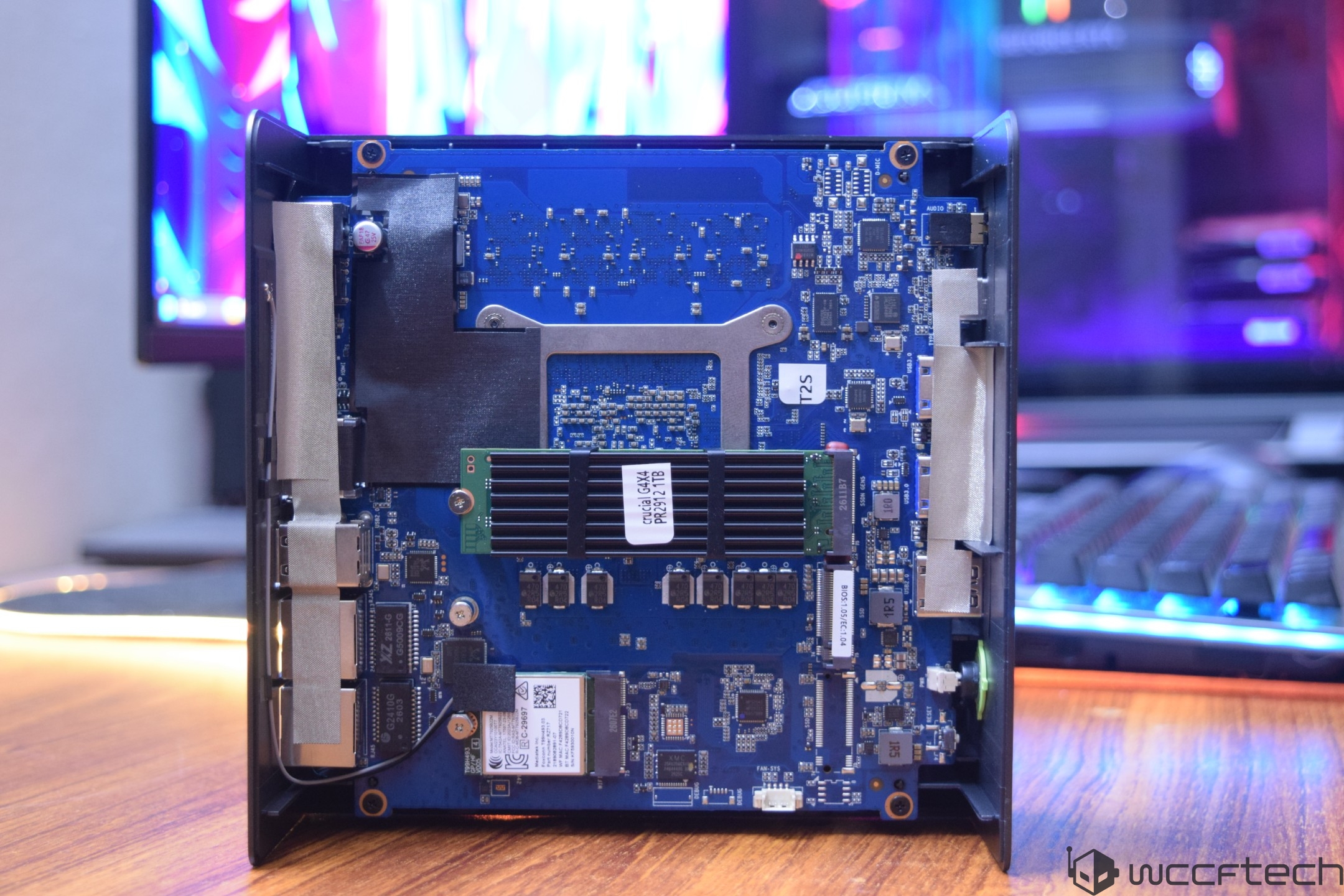 The interior of an ASRock DeskMini GTX series barebones PC chassis, showing a blue motherboard with visible RAM and heatsink module.