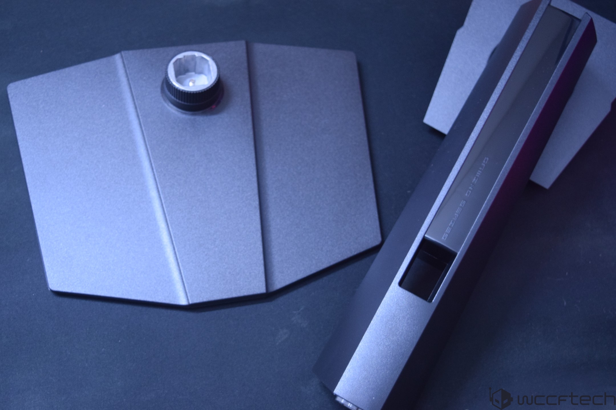Two parts of a Gigabyte Gaming Series stand separated on a dark surface.