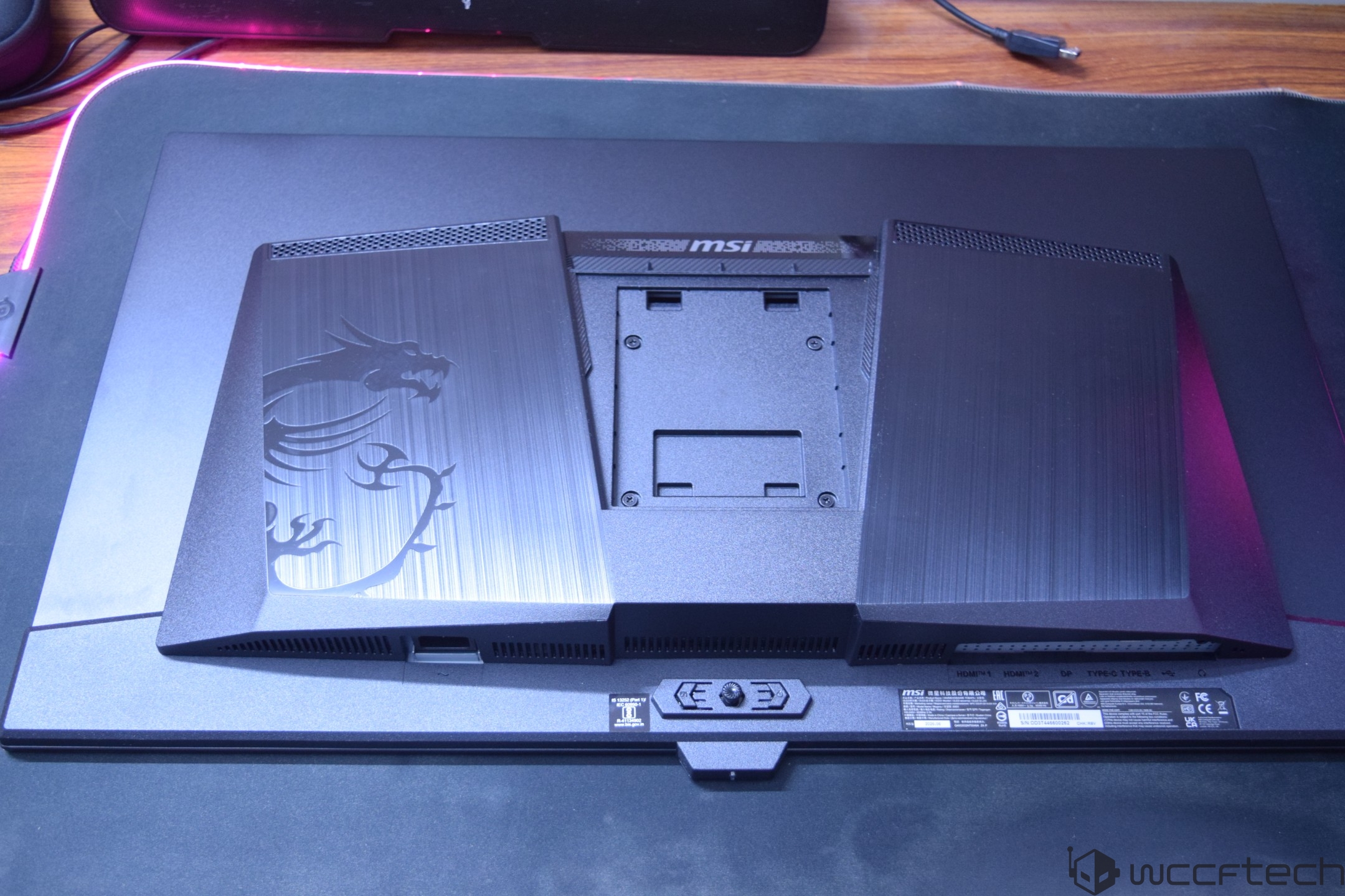 The backside of an MSI monitor with a visible dragon logo and multiple ports labeled 'HDMI 1', 'HDMI 2', 'DP', 'Type-C', and 'Type-B'.