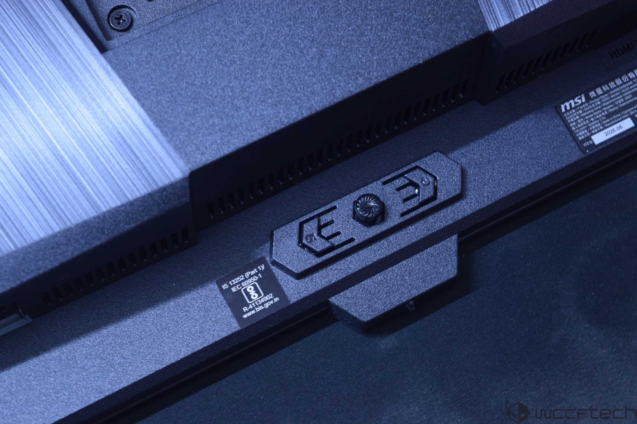 A close-up of the back of an MSI monitor featuring IS 13252 (Part 1) certification details.