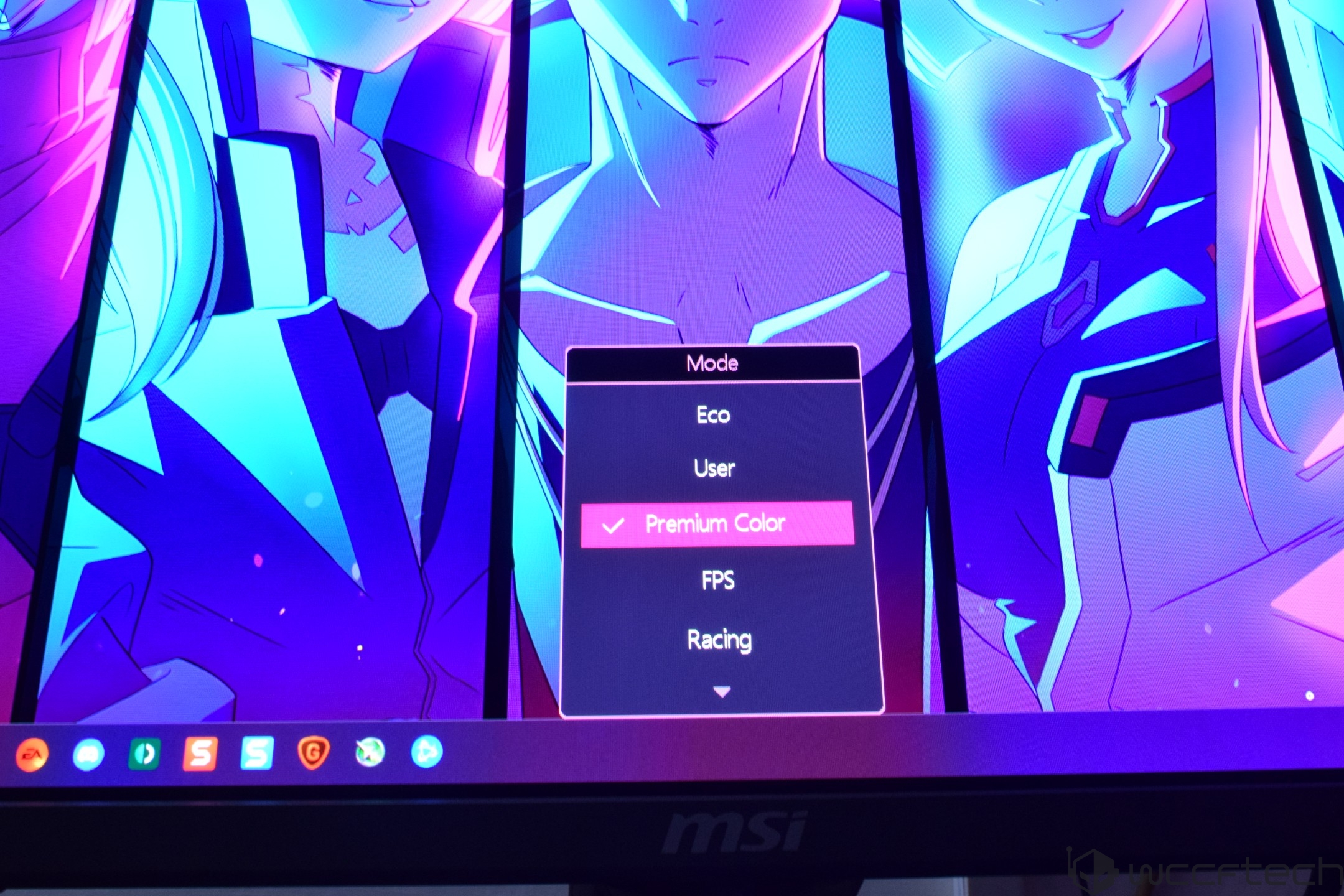 A computer monitor displays a vibrant anime wallpaper with an MSI logo below, and a settings menu on-screen with 'Premium Color' mode selected.