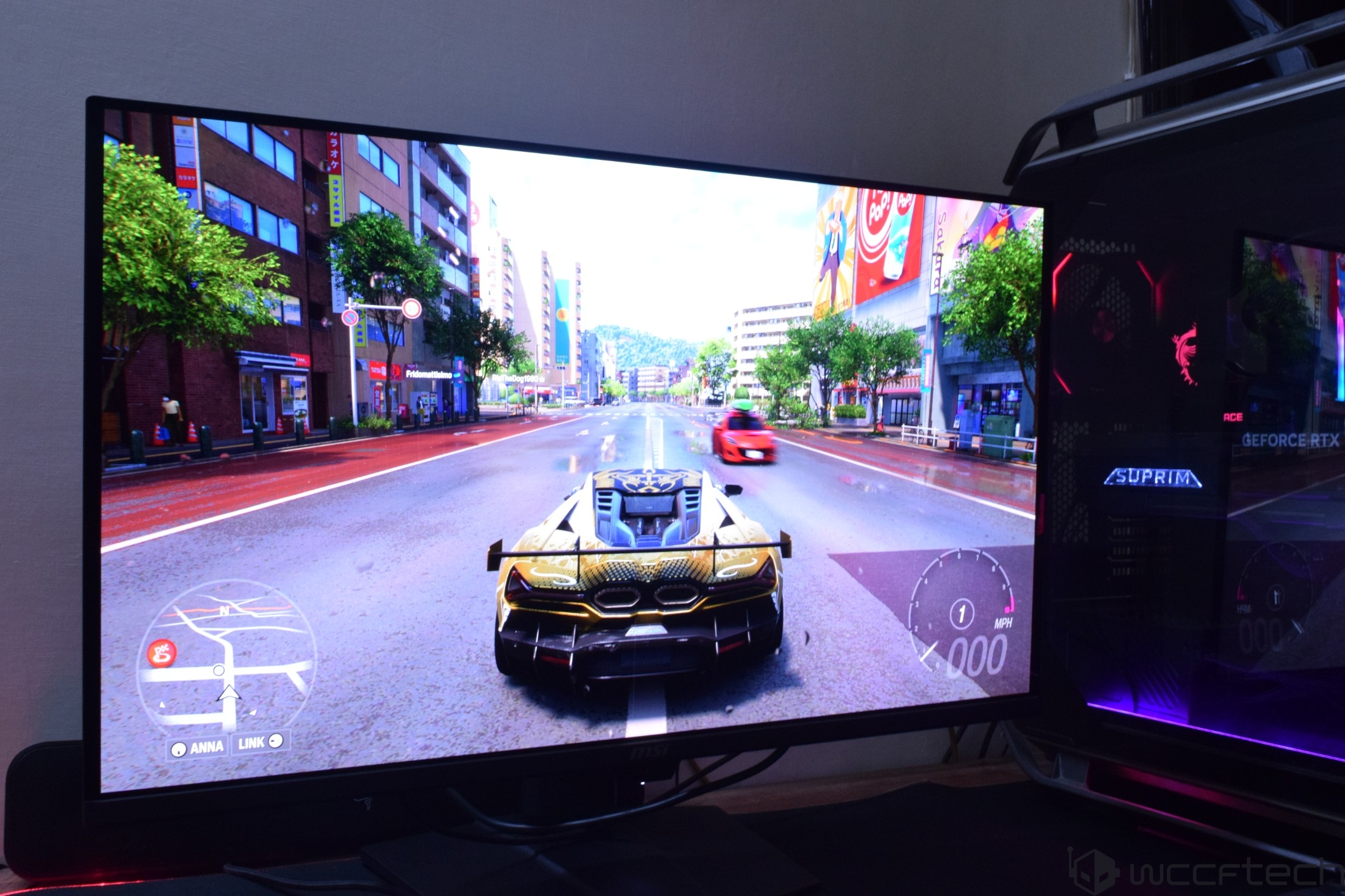 A racing game is displayed on an MSI monitor with a gaming desktop showing 'Suprim' branding and a GeForce RTX logo.