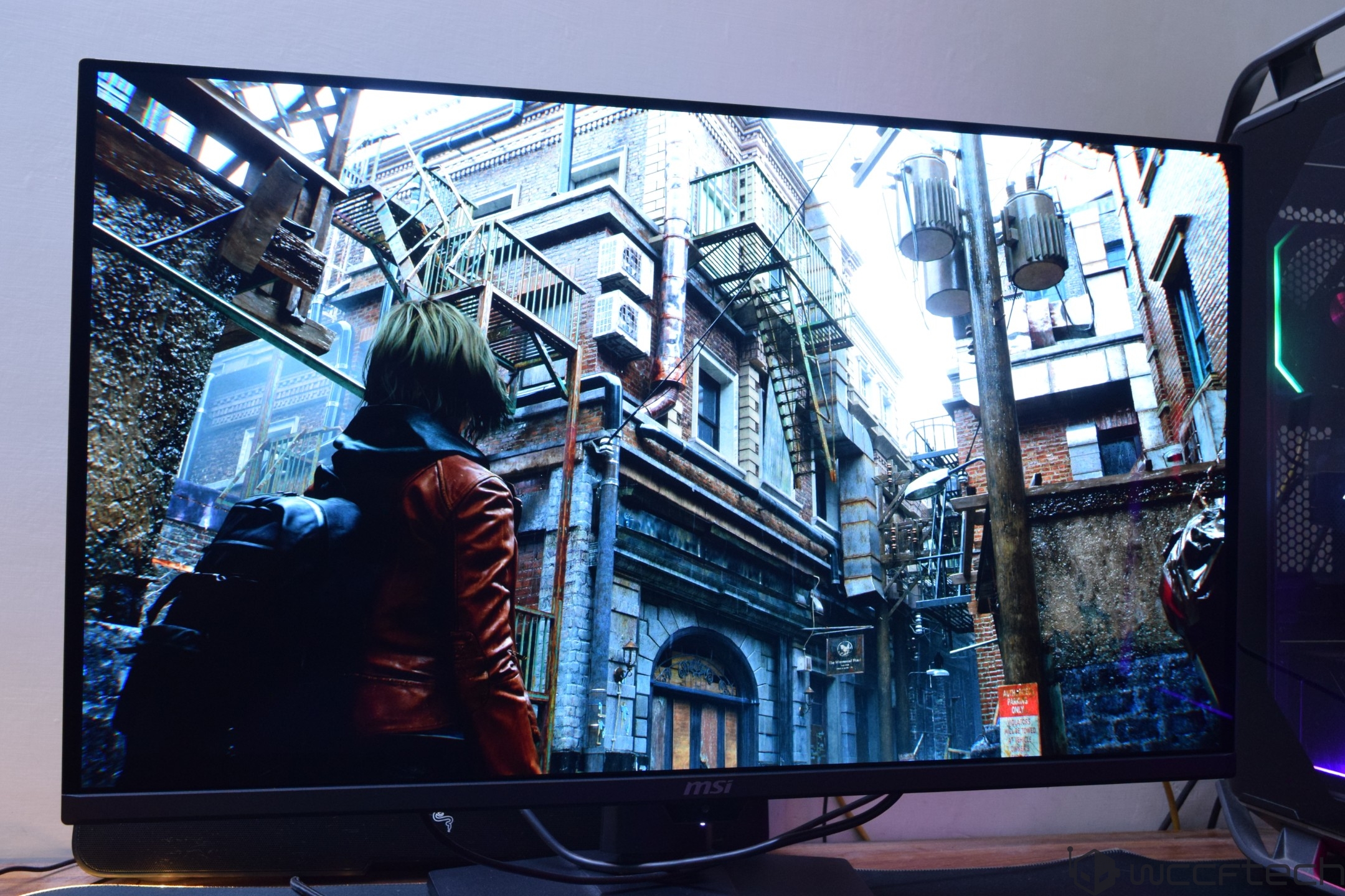 A character in a red jacket is exploring an urban environment in a game displayed on an MSI monitor.