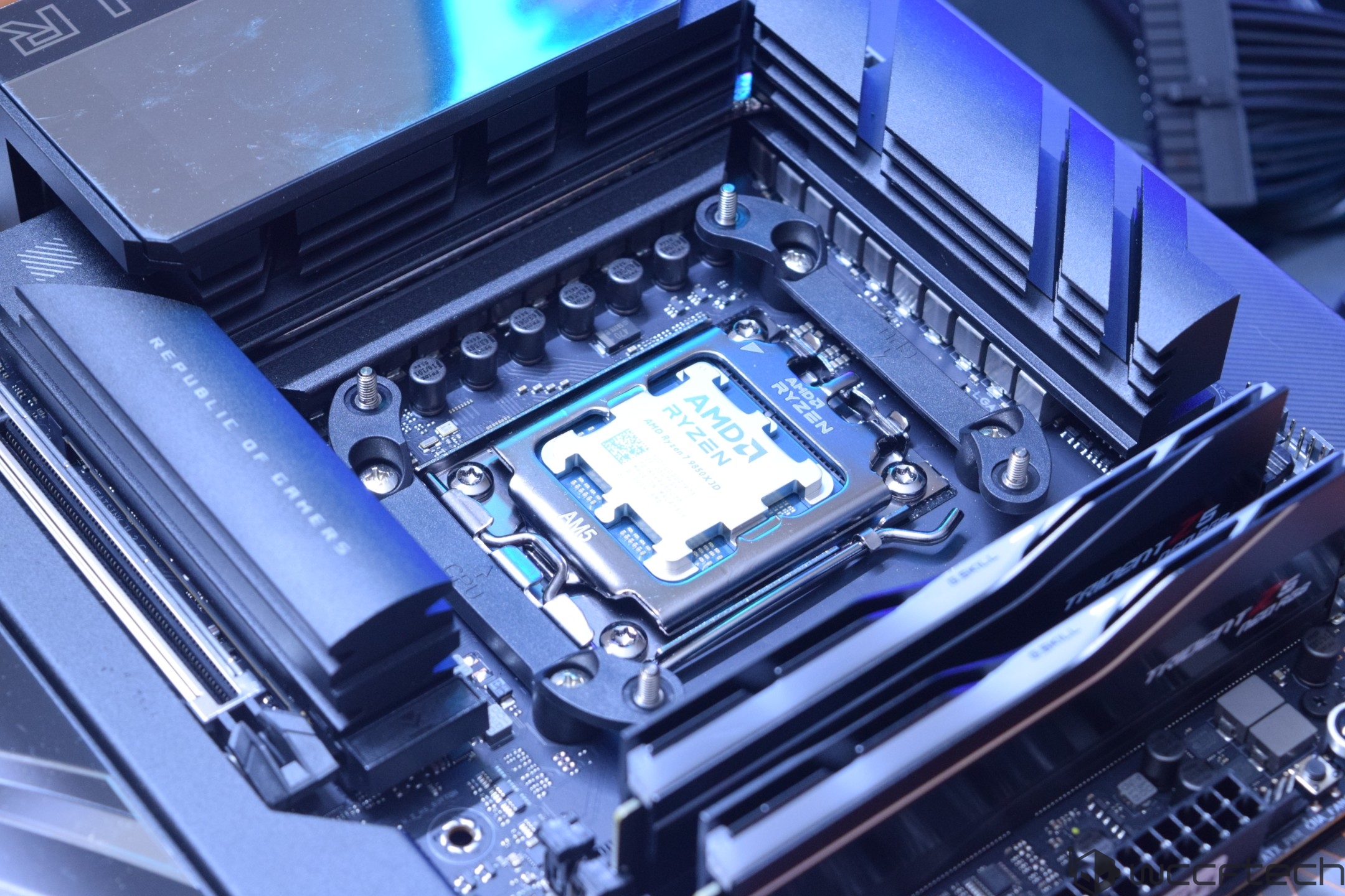 An AMD Ryzen CPU is installed on an ASUS Republic of Gamers motherboard, with visible G.SKILL Trident Z5 RAM modules.