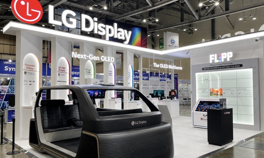The LG Display booth showcases a 'Next-Gen OLED' display and an interactive automotive interior concept with branded seating at a technology exhibition.