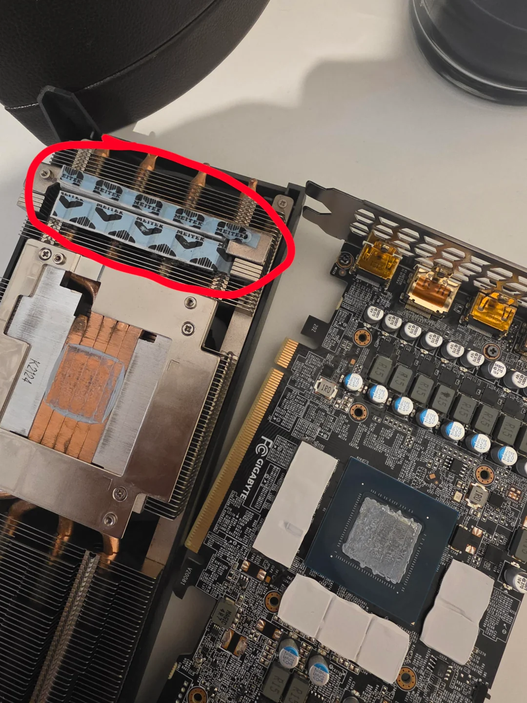 A disassembled Gigabyte graphics card with a visible heatsink labeled 'N1736.'
