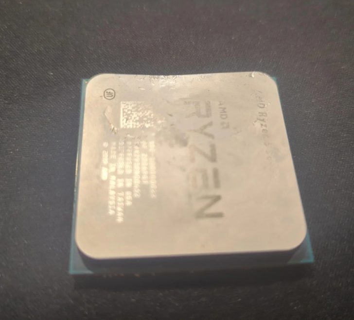 An AMD Ryzen processor, partially visible on a dark surface.
