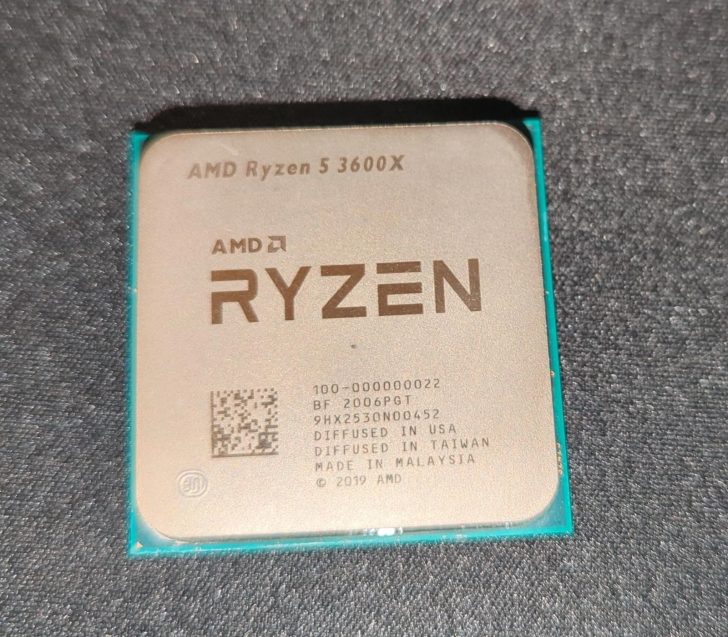 An AMD Ryzen 5 3600X processor with detailed markings and a QR code on its surface.
