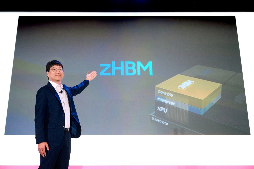 A presenter gestures towards a slide displaying 'zHBM' with a diagram labeled Core Die, Interlayer, XPU, and Substrate.
