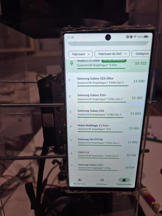 A smartphone screen displays benchmark rankings with the Samsung Galaxy S26 Ultra powered by Qualcomm Snapdragon 8 Elite Gen 5 leading, showing a score of 11,630.