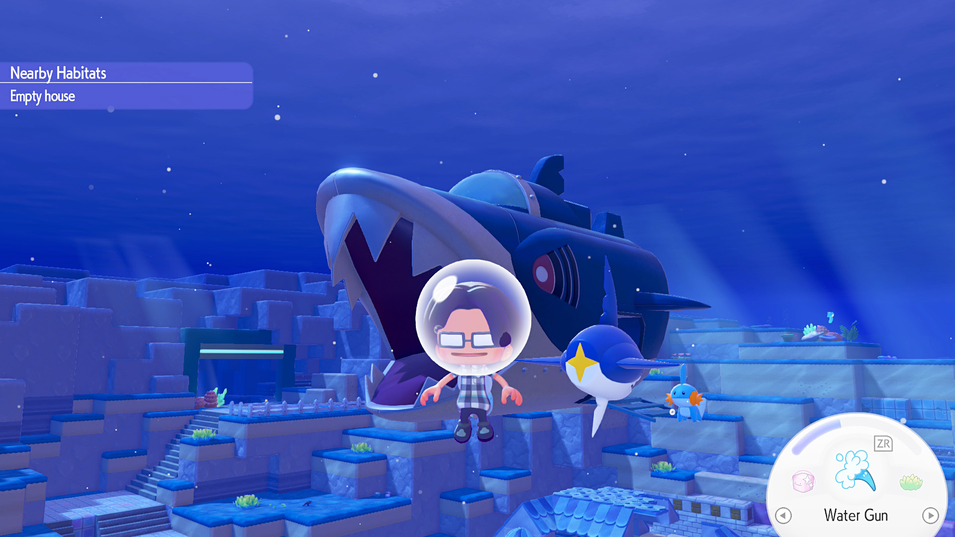 In 'Min-Aquarium,' a player character in a spacesuit floats underwater near a massive fish-like submarine, with a nearby menu option for 'Water Gun.'